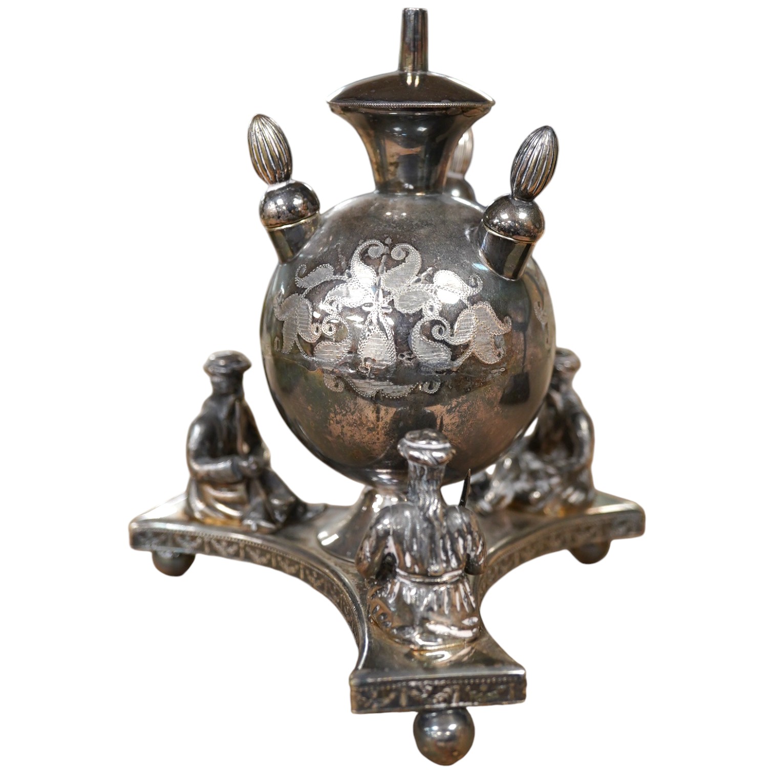 A Victorian plated cigar lamp decorated with seated Persian figures, 14cm high. Condition - fair